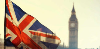 Union Jack flag waving in front of Big Ben in London