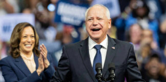 Two people speaking at a public event smiles cheering
