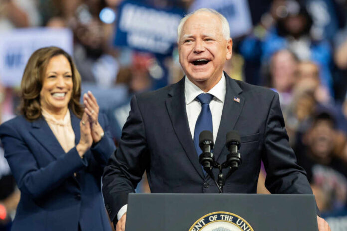 Two people speaking at a public event smiles cheering