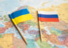 Ukraine and Russia flags on a map.