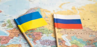 Ukraine and Russia flags on a map.