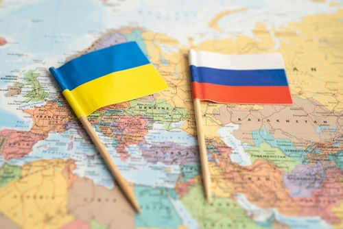 Ukraine and Russia flags on a map.