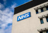 NHS sign on modern hospital building exterior