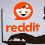 Anonymous Critics EXPOSED — Is Free Speech Dead? Silhouette of a person using a laptop in front of the Reddit logo