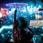 Anti-U.S. Sentiment? Mexico Club’s Shocking Price Move A DJ performing in a vibrant nightclub filled with dancing people