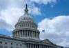 The dome of the U.S. Capitol building against a cloudy sky