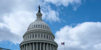 The dome of the U.S. Capitol building against a cloudy sky
