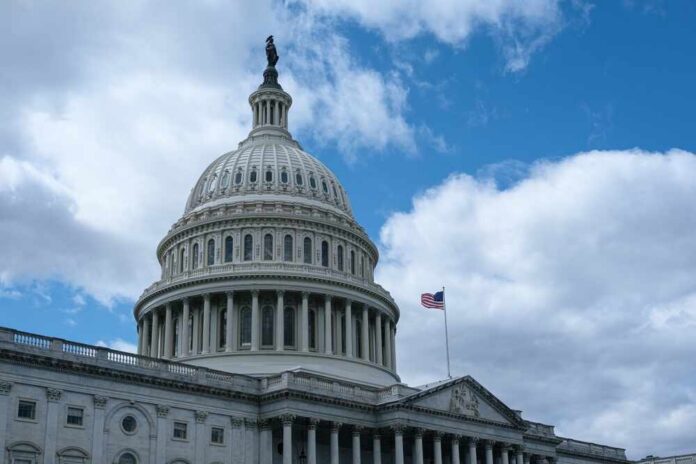 The dome of the U.S. Capitol building against a cloudy sky
