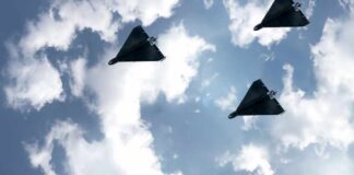 Three drones flying in a cloudy sky