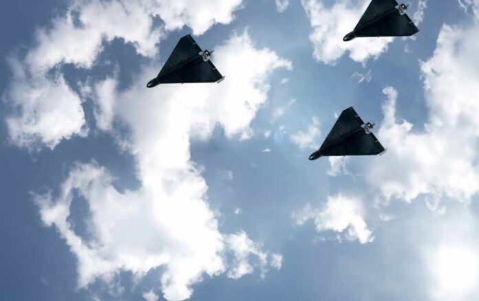 Three,Black,Kamikazes,Combat,Drone,In,The,Sky,Against,Clouds, Three drones flying in a cloudy sky