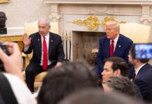 Two political leaders engaged in discussion in a formal setting