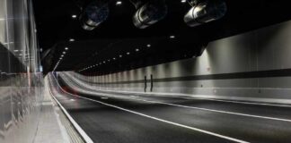 Interior view of a modern tunnel with illuminated road and ventilation systems