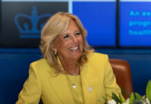 The Bestseller Claim Everyone Is Debating Smiling woman in a yellow blazer at a meeting table