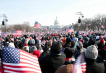 Crowd with flags in front of US Capitol building