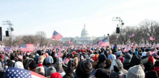 Crowd with flags in front of US Capitol building