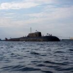 A submarine in the ocean with people on its surface