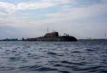 A submarine in the ocean with people on its surface