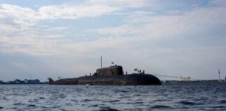 A submarine in the ocean with people on its surface
