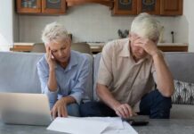 Americans Pay Price for Inflation Comeback Senior couple looking stressed while reviewing financial documents at home