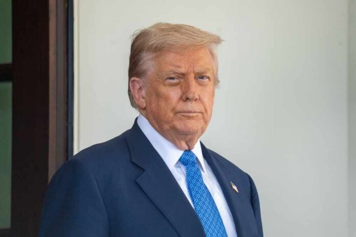 A political figure standing outdoors with a serious expression