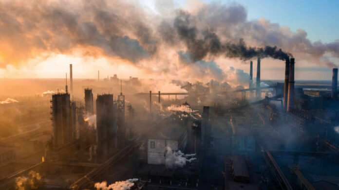 smoke-smog-emissions_1721153281-1 Industrial facility with smoking chimneys under a colorful sky