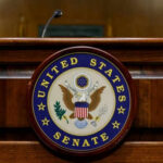 Election Integrity Bill Faces Senate Roadblock United States Senate emblem on wooden podium