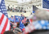 Crowd with flags near a government building