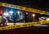 Police tape cordons off a nighttime crime scene