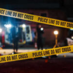 Police tape cordons off a nighttime crime scene