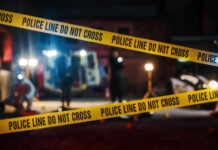 Police tape cordons off a nighttime crime scene