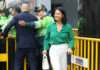 Election Cliffhanger Ends—Guess Who’s In I dont know who they are. Woman in green shirt smiling.