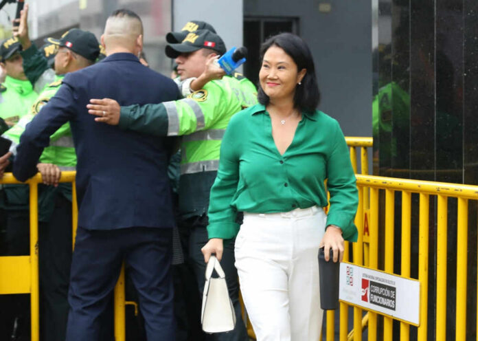 I dont know who they are. Woman in green shirt smiling.