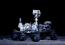 Mars rover with six wheels and camera mast on dark background