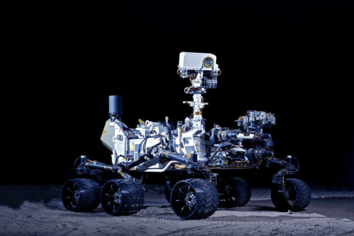 Mars rover with six wheels and camera mast on dark background