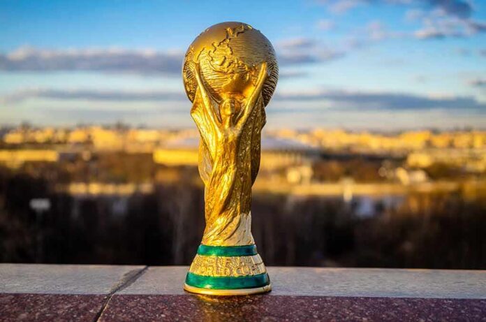 shutterstock_1070022398 Golden soccer world cup trophy outdoors
