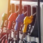 Oil Prices Soared—So Did Energy Profits Fuel pump nozzles in multiple colors at a gas station