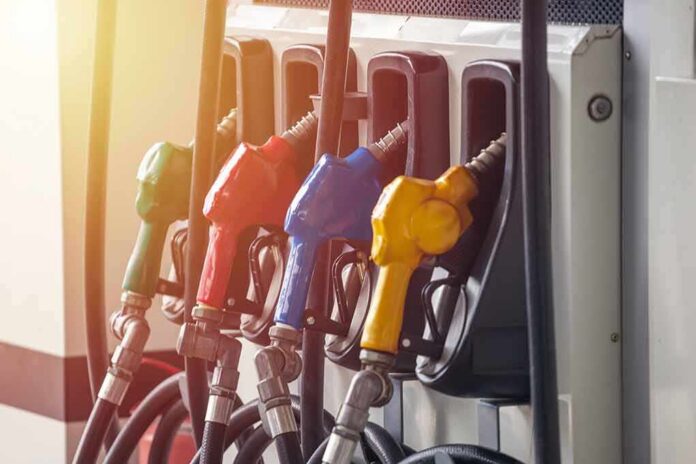 Fuel pump nozzles in multiple colors at a gas station