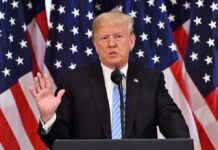 Assassination Night Do-Over: Trump Taunts Press man speaking at podium with American flags behind