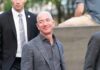 Jeff Bezos Linked To Liverpool Investment Talks bald man in a gray suit smiling outdoors
