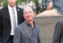 Jeff Bezos Linked To Liverpool Investment Talks bald man in a gray suit smiling outdoors