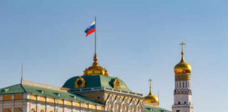 The Kremlin building with the Russian flag and golden domes in the background