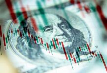 us dollar bill with stock candlestick chart overlay