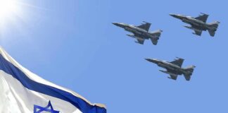 Israeli flag with three fighter jets flying overhead