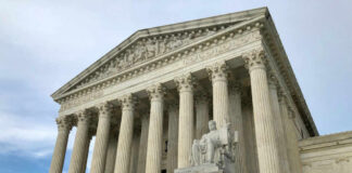 United States Supreme Court building with columns and statue