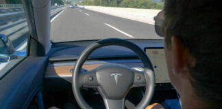 Person using autopilot in Tesla on highway.