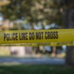 yellow police tape cordoning off an outdoor area