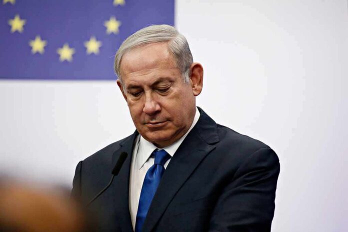 man in suit at podium with EU flag in background