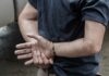 person in handcuffs with hands behind back
