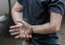 person in handcuffs with hands behind back