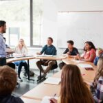Teacher speaking to students in a classroom discussion